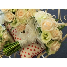 Vandela rose, lisianthus and veronica with asparagus fern, enhanced with pearls and voile ribbon.