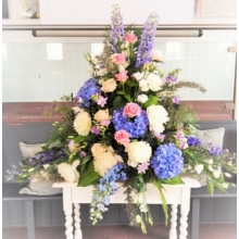 Sweet Avalanche and Heaven rose,  peony, hydrangea, lisianthus, freesia, delphinium and veronica with coordinating foliage.