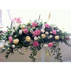 Aqua and Sweet Avalanche rose, hydrangea, lisianthus and lysimachia with coordinating foliage.
