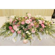 Amnesia and Avalanche Pink roses, bouvardia, lisianthus, freesia and September flower with mixed foliage.