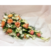 Miss Piggy rose, calla lily, freesia and lisianthus with asparagus fern enhanced with crystal butterflies. 