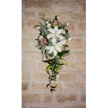 Amnesia rose, lily and lisianthus column design with coordinating foliage enhanced with diamanté clusters.