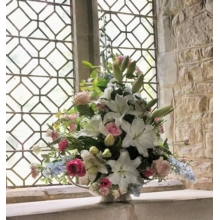 Church window sill vase filled with Sweet Avalanche, Avalanche Pink and All 4 Love roses, delphinium, lily, lisianthus and veronica with coordinating foliage.