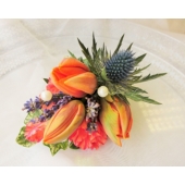 Ladies corsage of tulip, eryngium and lavender enhanced with pearls