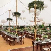 Side view of tables and foliage chandeliers