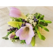 Wrist corsage on pearl bracelet with freesia, gypsophila and lavender.