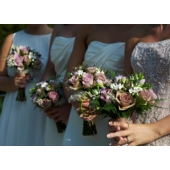 Bride and bridesmaid's hand tied bouquets containing Ocean Song & Memory Lane rose, calla lily, freesia and gypsophila with asparagus fern, enhanced with lavender springs.
